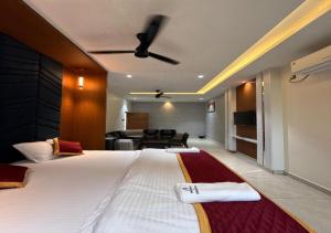 a bedroom with a large bed and a living room at SNR GRAND in Narasaraopet +14 photos