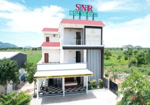 a building with a sign on top of it at SNR GRAND in Narasaraopet