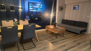 a living room with a table and a couch at Liro Apartments Düsseldorf in Düsseldorf