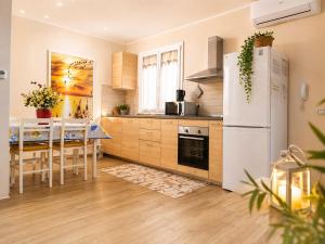 a kitchen with a table and a white refrigerator at Marino Apartments in Levanto