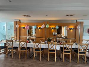 a dining room with a long table and chairs at Hotel Am Schlosspark , Wiesbaden in Wiesbaden
