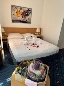 a hotel room with a bed and a table with a tray at Hotel Am Schlosspark , Wiesbaden in Wiesbaden