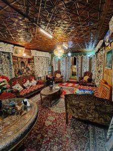 a living room with a couch and a table at Houseboat young Minar in Srinagar