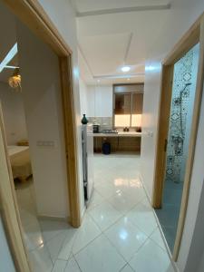 a room with a kitchen with a refrigerator at Appartement Tourma in Agadir