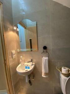 a bathroom with a sink and a mirror and a toilet at Appartement Tourma in Agadir +12 photos