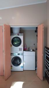 a laundry room with a washer and dryer at Thyme On The Terrace in Te Anau