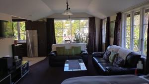 a living room with a couch and a table at Thyme On The Terrace in Te Anau