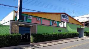 a colorful building with a sign on the side of it at Hotel tenda 2 in Guarulhos