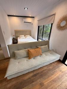 a large couch in a room with a bed at Refugio El Benja in Villa Salto Encantado +27 photos
