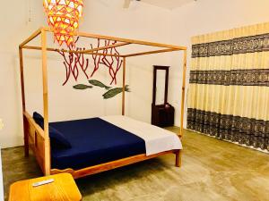 a bedroom with a bed and a basketball hoop at Paradise Bay Hotel in Arugam Bay +11 photos