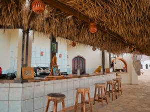 a bar with stools in front of a restaurant at Dana beach camp in Nuweiba
