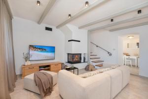 a living room with a couch and a tv at Villa Rocco in Kozljak