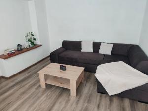 a living room with a couch and a coffee table at Dom priamo pri rieke in Opatovce nad Nitrou