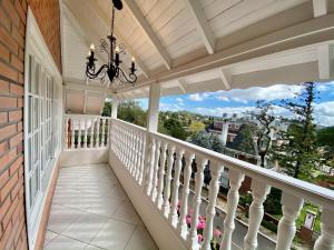 a balcony of a home with a chandelier at Lapônia Hotel Gramado in Gramado