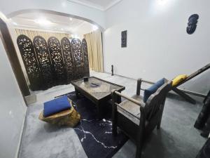 a living room with a couch and a table at The Nest in Aso