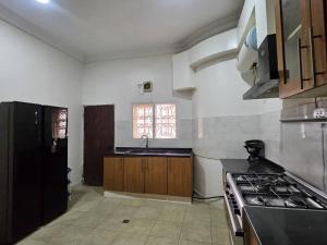 a kitchen with a sink and a stove top oven at The Nest in Aso