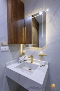 a bathroom with a white sink and a mirror at Khofo pyramids view inn in Cairo