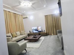 a living room with a couch and a table at The Nest in Aso