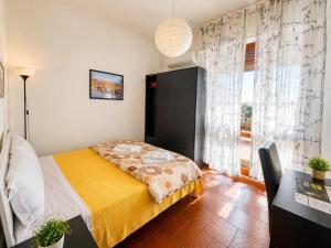 a bedroom with a bed and a large window at B&B Colombo in Pisa