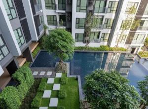 an apartment building with a swimming pool and trees at Thong Lor condo Next to BTS in Bangkok