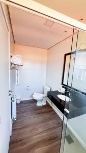 a bathroom with a toilet and a sink at Lapônia Hotel Gramado in Gramado +102 photos
