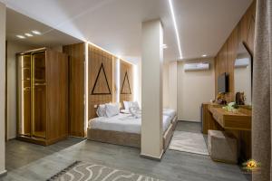 a bedroom with a bed and a desk and a sink at Khofo pyramids view inn in Cairo