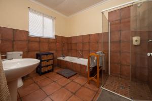a bathroom with a tub and a sink and a shower at Van Zylsvlei - A Karoo Guest Farm in Colesberg +31 photos
