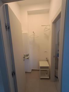 a hallway with a small table in a white room at Bouganvillea in Senigallia +43 photos