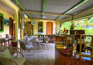a restaurant with a bar and tables and chairs at Buisson Guesthouse in La Digue +20 photos