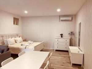 a small bedroom with two beds and a dresser at Casa de Casarelhos - "Gerês" in Geres