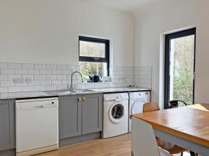 a kitchen with a sink and a washing machine at Cottage 503 - Leenane in Leenaun