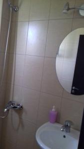 a bathroom with a sink and a mirror at Apartment Irini in Agios Nikolaos