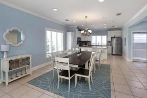 a dining room and kitchen with a table and chairs at Five on the Beach by Pristine Property Vacation Rentals in Cape San Blas