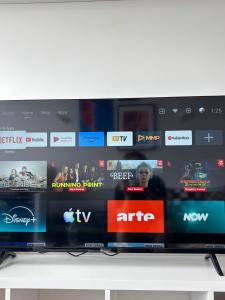a television screen with a bunch of different websites at Cosy Newtown apartment in Vilnius +3 photos