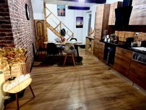 a kitchen and dining room with a table and a counter at Bohéme Chic in Saint-Dizier