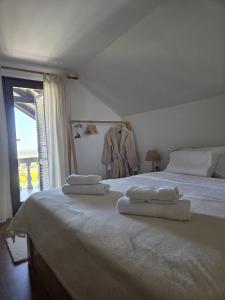 a bedroom with a white bed with towels on it at Kraljeva Kruna - kuća za odmor in Koprivnica +99 photos