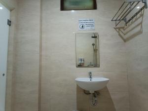 a bathroom with a sink and a mirror at The Cabin Hotel Wirobrajan in Yogyakarta +7 photos