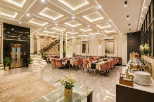 a restaurant with tables and chairs in a room at Hotel Wilkisto By Amar Singh Near Taj Mahal in Agra