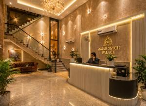a man sitting at a counter in a lobby at Hotel Wilkisto By Amar Singh Near Taj Mahal in Agra +24 photos