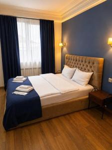 a bedroom with a large bed with blue walls at BB Old City in Tbilisi City +37 photos