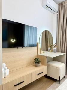 a living room with a large television on a wall at Central View Apartment in Timişoara