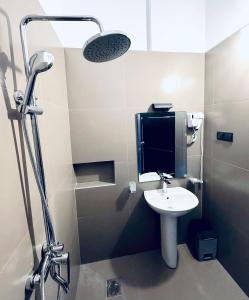 a bathroom with a sink and a shower with a mirror at ARHH castle in Ginigathena +18 photos