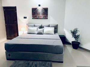 a bedroom with a bed and a potted plant at ARHH castle in Ginigathena