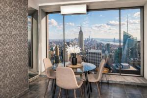 a dining room with a view of the city at Highrise Horizon Penthouse in Budapest
