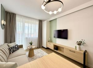 a living room with a couch and a flat screen tv at Central View Apartment in Timişoara