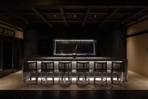 a bar in a dark room with bar stools at MUSUBI Hakone in Sengokuhara