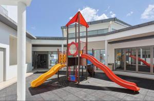 a playground with a slide in a building at Sungai palas Horizon in Cameron Highlands