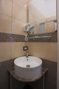 a white sink in a bathroom with a mirror at Rosa Italia Hotel Roma in Rome +39 photos