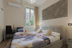 a bedroom with a bed with decorations on it at Rosa Italia Hotel Roma in Rome