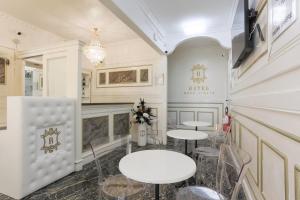 a room with two tables and two chairs at Rosa Italia Hotel Roma in Rome